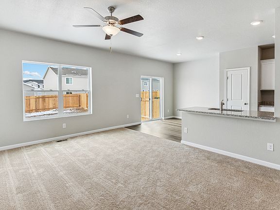 Open layout with the kitchen overlooking the living room and dining area.