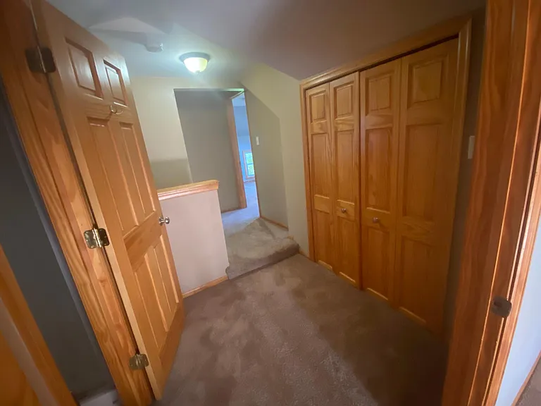hallway between bedrooms with extra closets