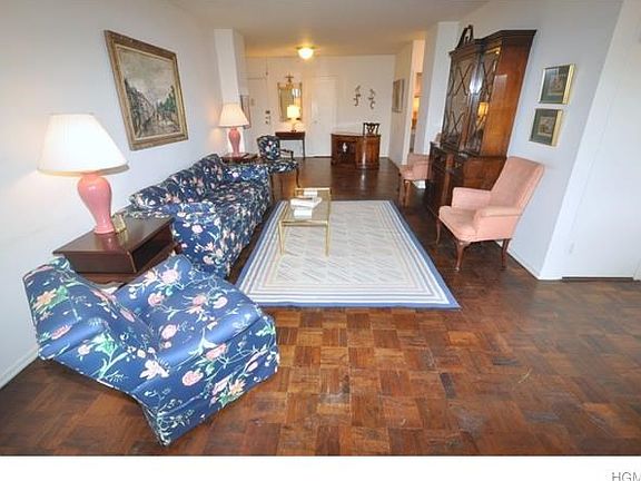 Large sunny living room opens to the "L" shaped dining room. There is a door that leads to a private