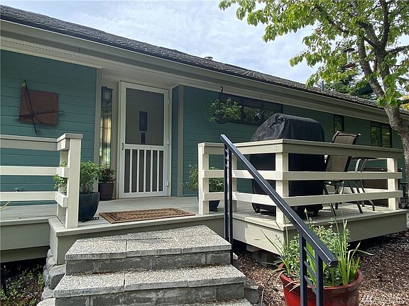 The welcoming front entrance with its classic wood-framed screen door.