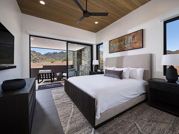 Serene primary bedroom suite with direct access to covered patio