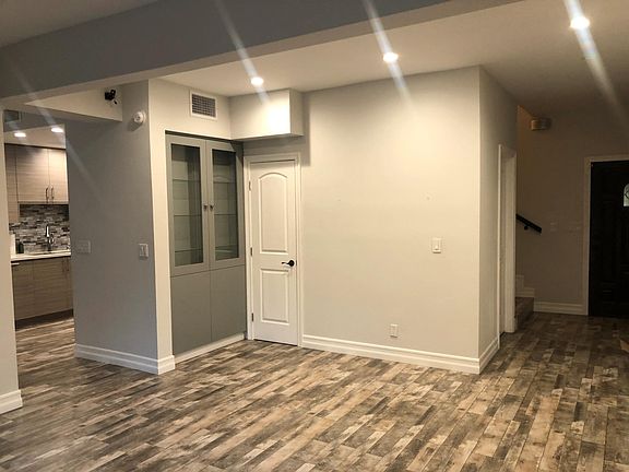 Front entrance, staircase, downstairs bathroom, closet, kitchen