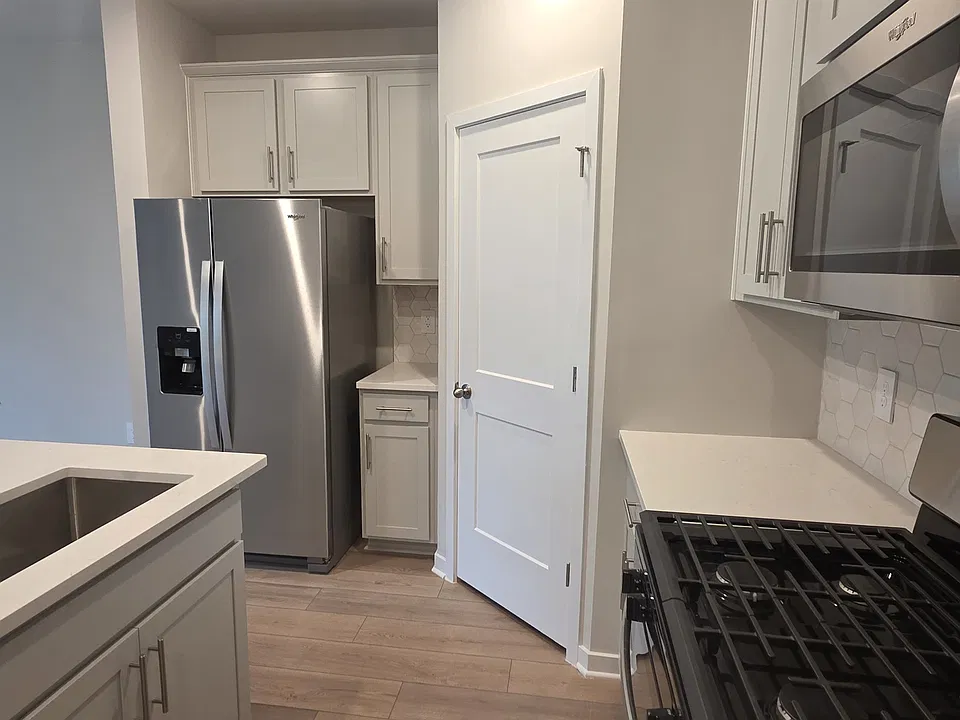 Granite island with Whirlpool dishwasher and sink with disposal. Whirlpool gas stove and microwave and vent hood, corner full pantry. Whirlpool refrigerator/freezer with ice machine and water dispenser.