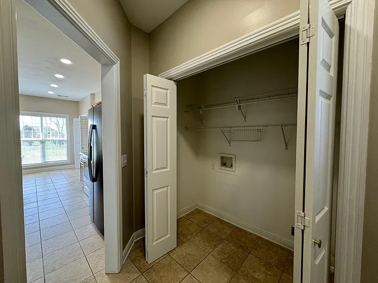 Laundry Room with connections and space for a large washer and dryer Between the Kitchen and the stairs to bonus room/door to garage
