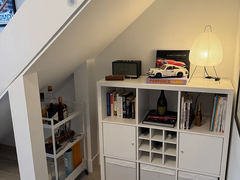 Spandrel (I had to Google this too) - Charming spandrel under the stairs offering ample space for extra storage, a stylish bar cart, or a well-curated bookshelf_adding both function and character to the home.