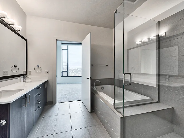 Spa inspired bathroom with glass shower, soaking tub and dual vanity