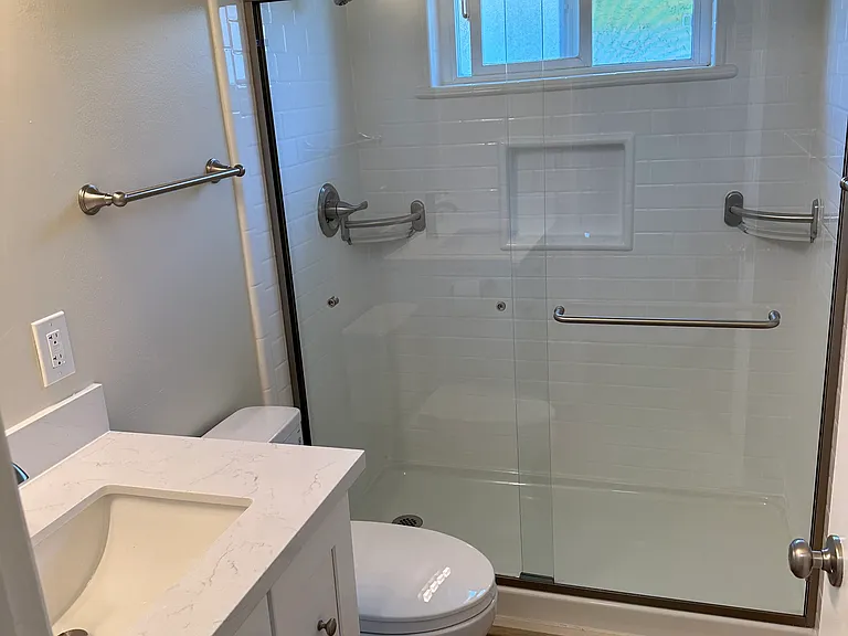 New stall shower, niche, corner shelves, & new shower door, Toto toilet, new fixture/ vanity setup.