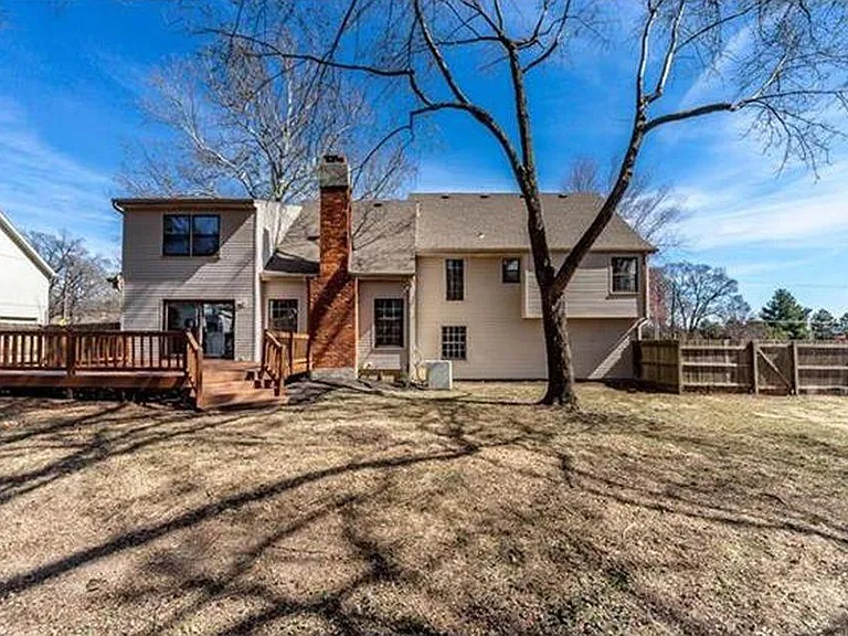 Fenced backyard with large deck