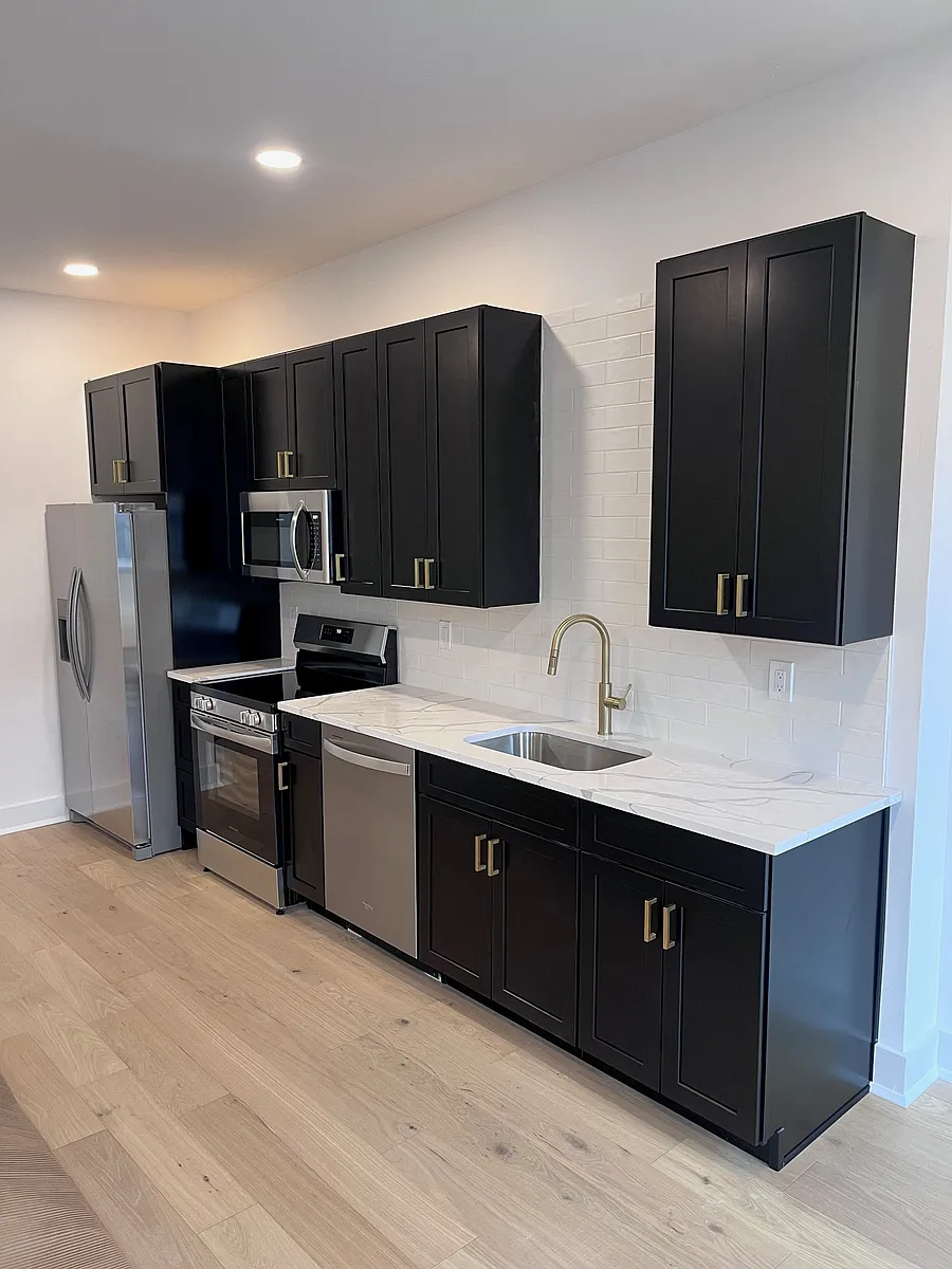 Designer Kitchens: High-end quartz countertops, elegant shaker cabinetry, custom tile backsplashes, and full-size stainless steel appliances. *Layout presented is from apartment 2 - each unit has a unique kitchen layout* - 52 S 5th St #1