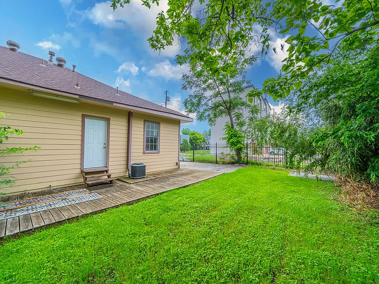 Relax on the private back deck overlooking a lush green lawn.