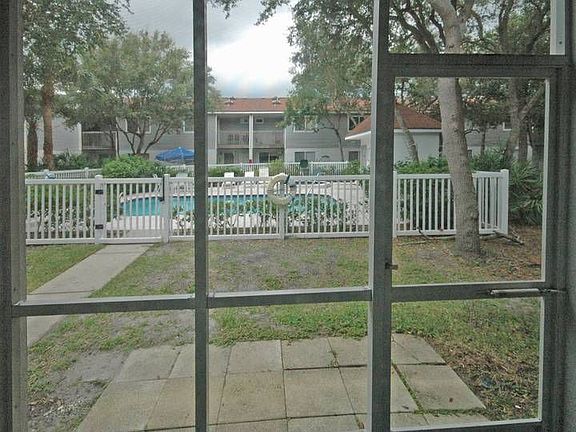 Small paver patio outside the first floor lanai is perfect for grilling.
