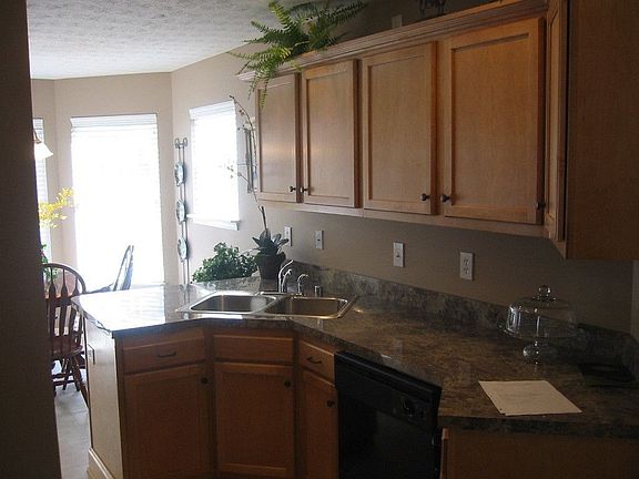 Kitchen includes dishwasher, range, microwave, and disposal