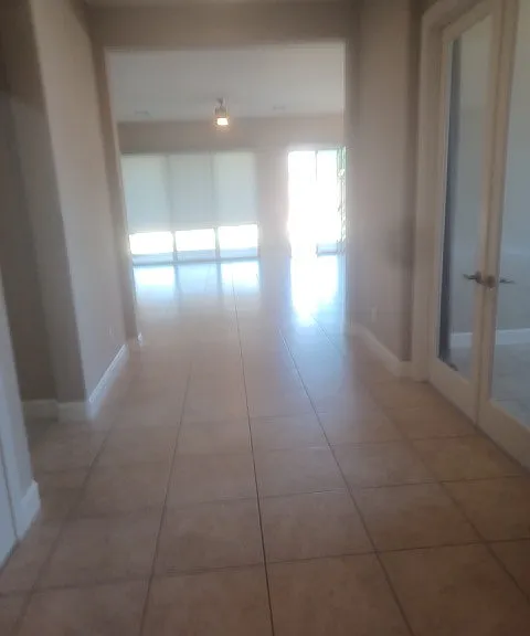 Entry, Den on the right, also Bedroom and full bath, on the left Laundry room and 3 car garage