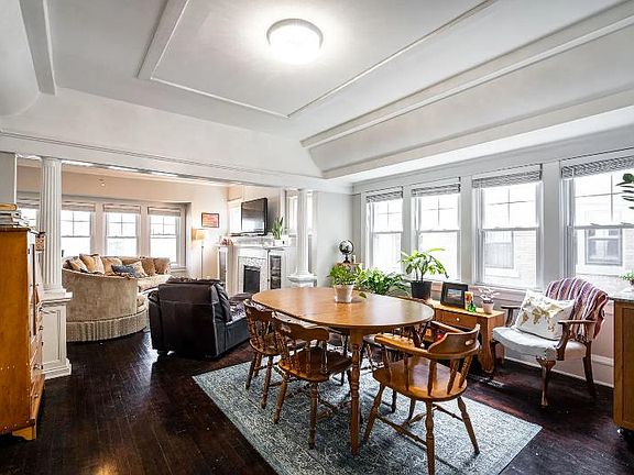 Dining room with crown molding and columns.