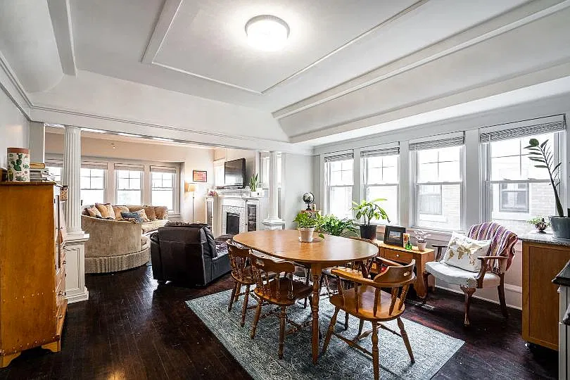 Dining room with crown molding and columns.