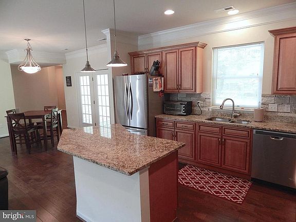 Kitchen view into Dining Rm. Doors to rear Patio