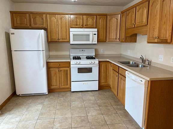 Fully applianced solid oak kitchen with all appliances provided, including microwave and garbage disposal