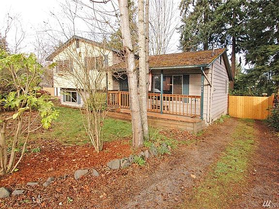 The back yard and garage access are located behind the fence gate on the right.  