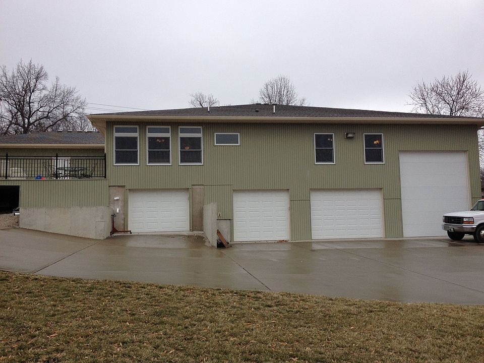 Back of home with 4 garages