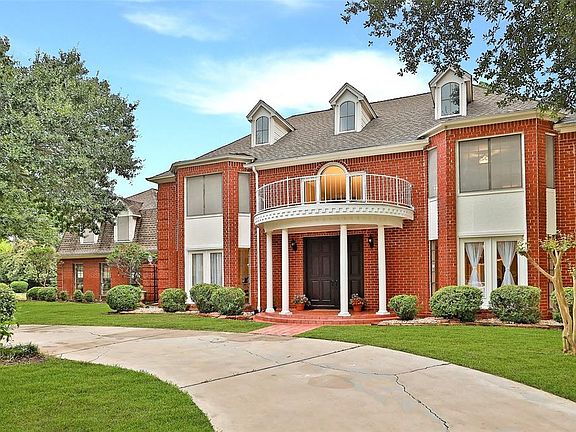 WELCOME HOME: The handsome double mahogany front doors create a stately and pretty entrance. You will marvel at the intricate details of the custom designed millwork that graces the house throughout. These gracious details are rarely featured in home