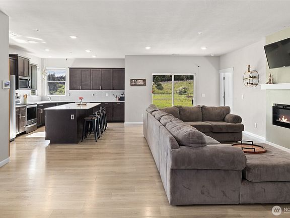 Living room is open to the kitchen and dining area.>