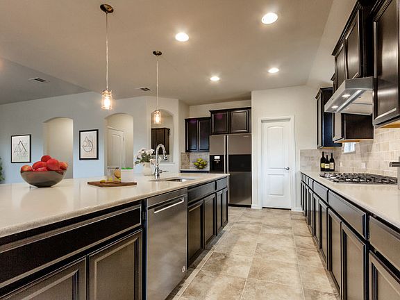 Spacious kitchen with abundant cabinet space and recessed lighting