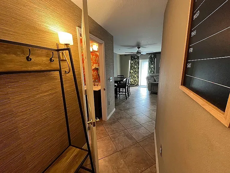 First floor hallway with 1/2 bathroom on left side