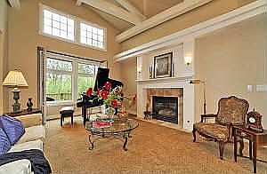 Living room with vaulted ceilings & exposed beams.