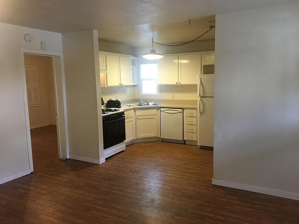 Kitchen with 3rd bedroom entrance to the side. Kitchen has self cleaning gas range, Dishwasher and refrigerator. To the right of kitchen is laundry room and pantry and bathroom