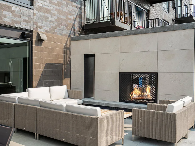 Cozy up by the fire in a stylish outdoor lounge designed for comfort and conversation.