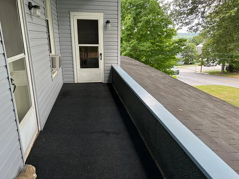 Upstairs porch. Door at the end into apartment 4.
