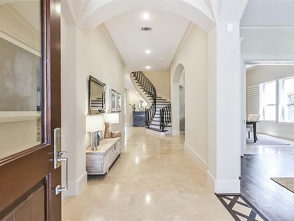 Fabulous entry into this light and bright home. Gleaming tile throughout most of the first floor (with the exception of hardwoods in the formal living room at the front of the home)