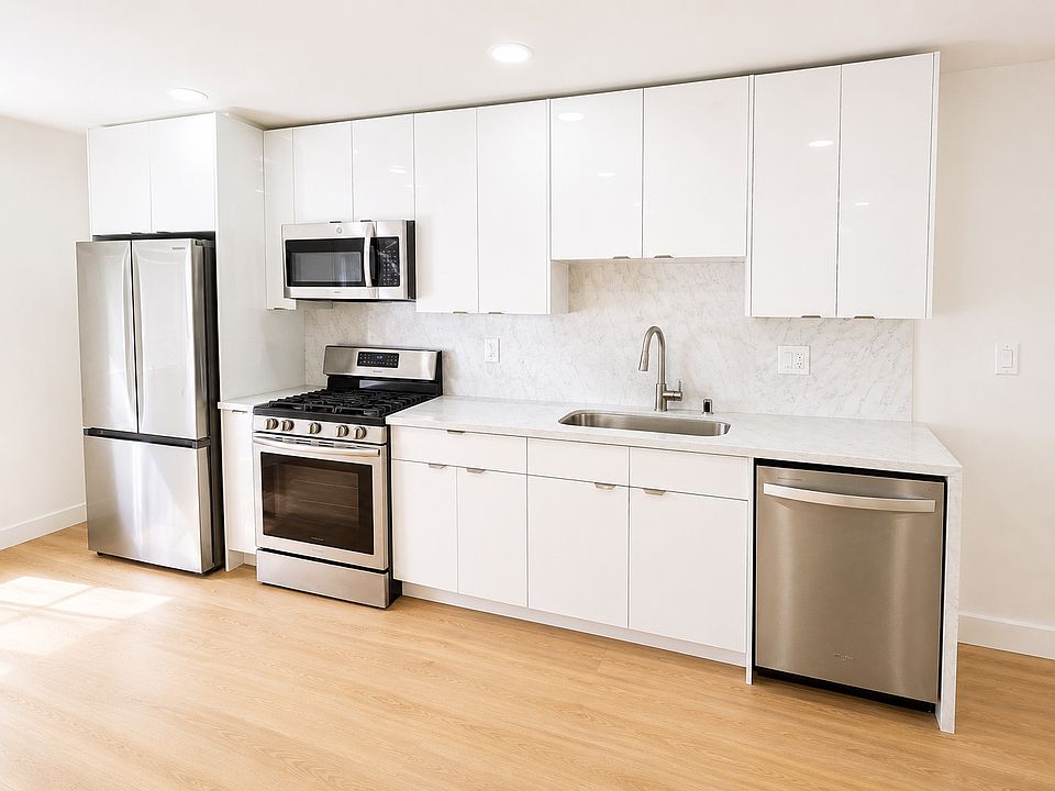 Sleek galley-style kitchen with modern cabinetry, stainless appliances, and generous counter space.