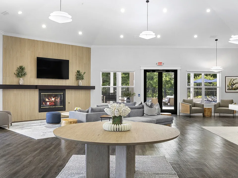 Resident clubroom with fireplace and sectional seating, made for settling in with friends