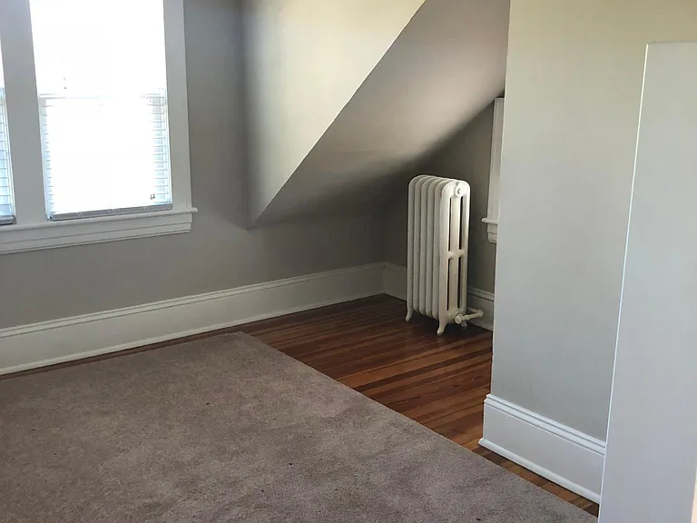 Entrance to first bedroom, with three windows