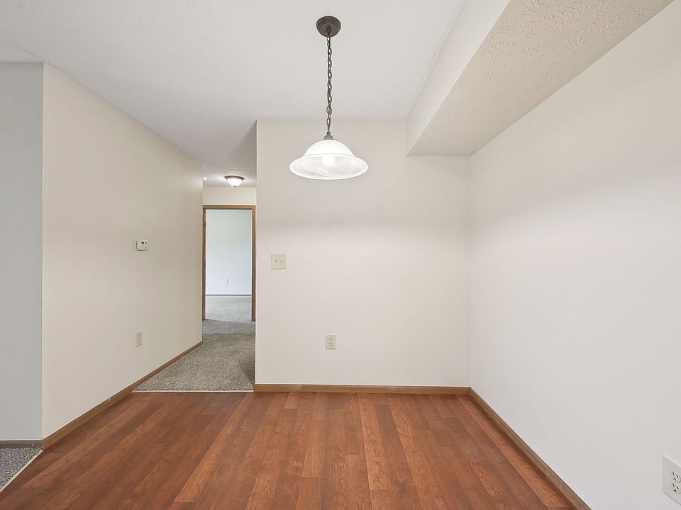 Dooley's Orchard apartment unit showing a dining area off the kitchen, with a hallway leading to a bathroom and bedroom.