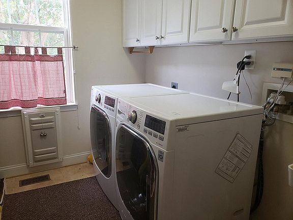 New LG HE washer and dryer with ample laundry storage.