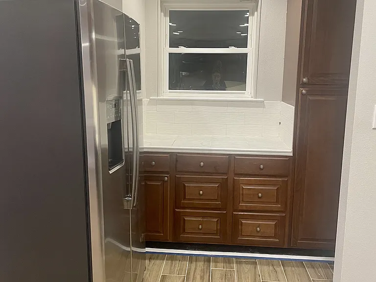 Kitchen offers additional cabinet storage and expanded countertop space, along with a brand-new refrigerator for added convenience.