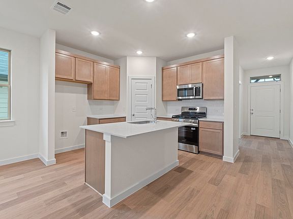 Kitchen in the Pearl home plan by Trophy Signature Homes - REPRESENTATIVE PHOTO