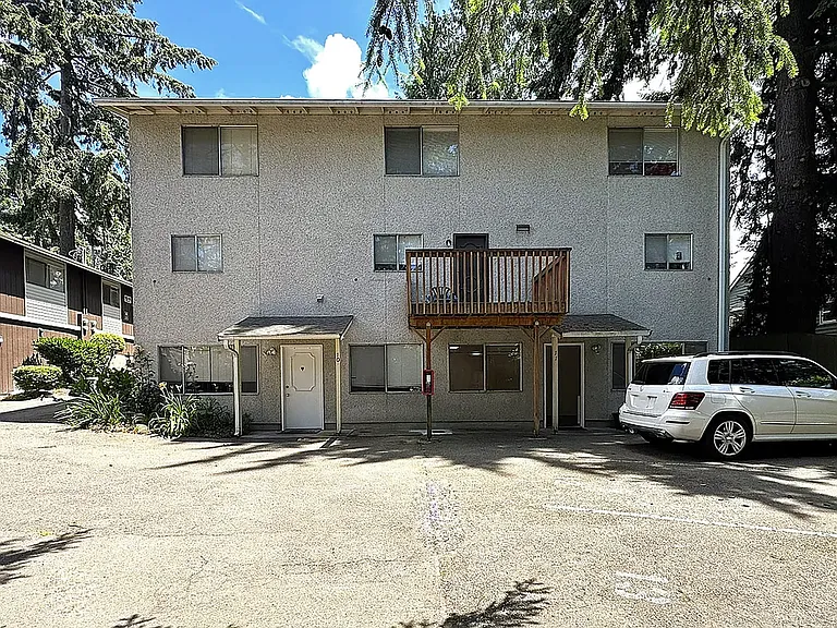 West side of building with adjacent parking.
