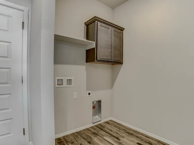 Laundry room off of kitchen. Door to the left is the garage.