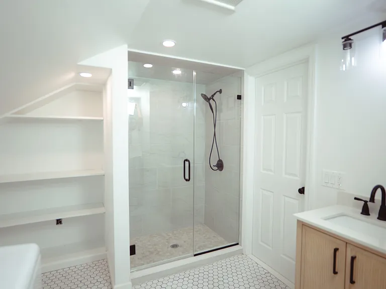 Second floor bathroom. Newly renovated with washer & dryer and storage.