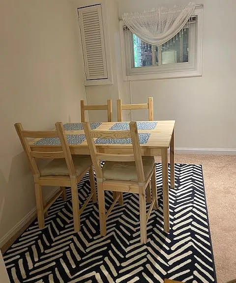 Dining area comes with table, chairs, and carpet.