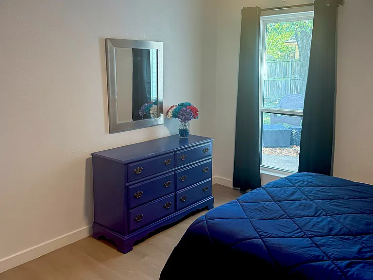 Dresser and window looking out at patio