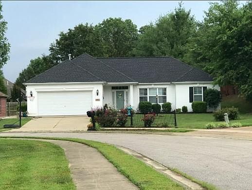 This brick home is painted white. It is beautiful and has a fenced in backyard. The home is located on a cul-de-sac with a lake view. The backyard is private with mature trees. Walking neighborhood with sidewalks.