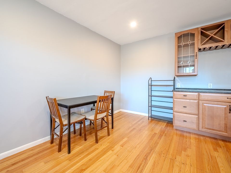 Dining area furnished with dining table, chairs, and metal shelving