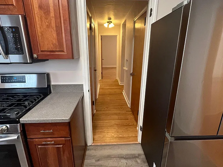 Hallway from kitchen to 2 bedrooms and bath