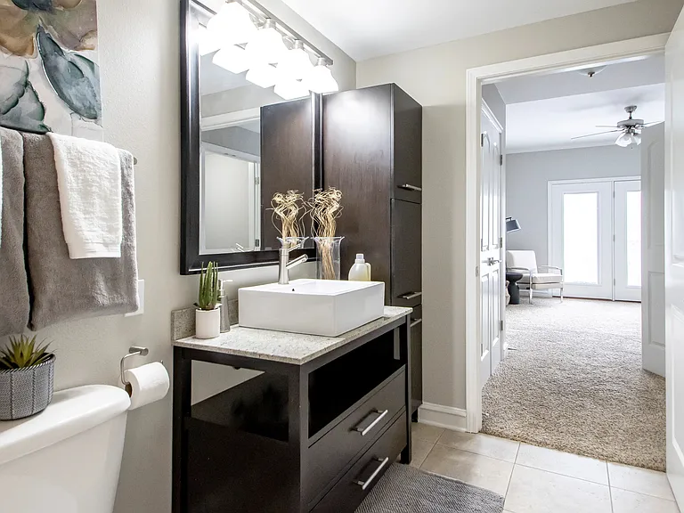 Immerse yourself in opulence seamlessly flowing from your regal bedroom to the opulent master bath, boasting lavish design with granite countertops and sumptuous cabinet space, embodying sophistication and luxury.