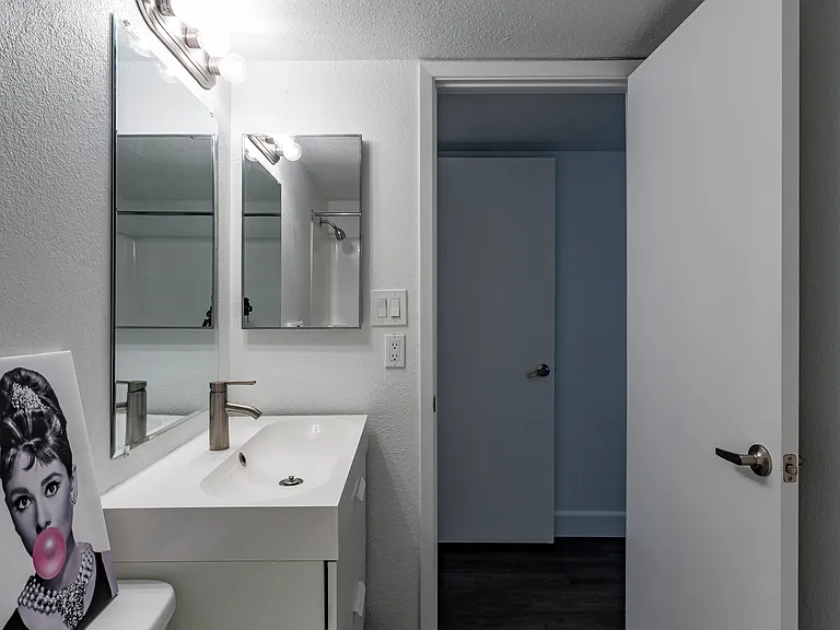 Great hall bathroom with vanity storage and tub/shower combination.