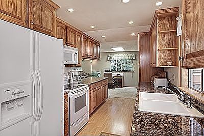 Fully remodeled kitchen w/slab granite, recessed & undermount lighting.